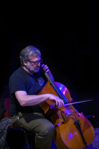 David Goldblatt plays the cello onstage.